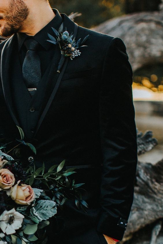 groom in all black suit