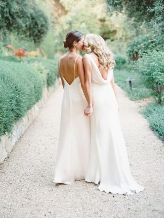 Two brides holding hands