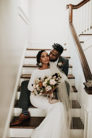 bride and groom sitting on staircase