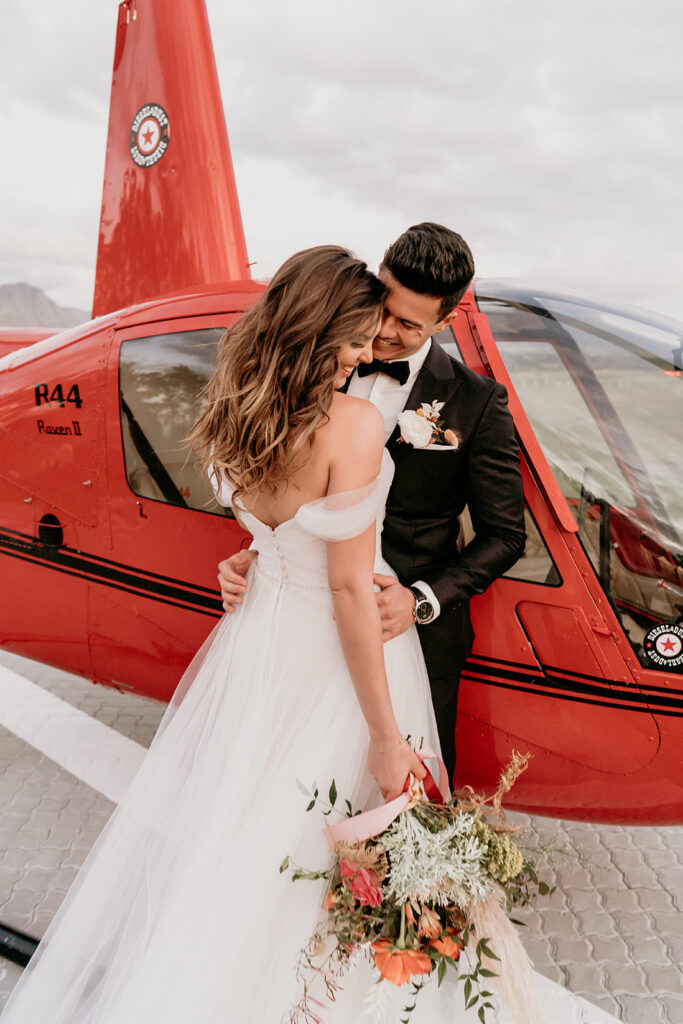 Couple in front of helicopter